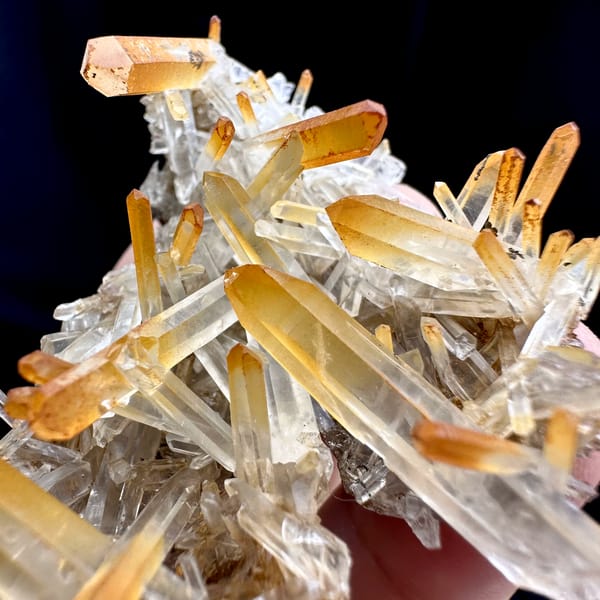 Clear quartz needles with mango-orange tips from Jinkouhe, Sichuan, China, top view