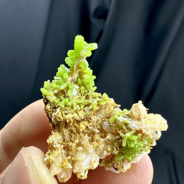 Bright lime-green pyromorphite tufts on tan matrix from Guangxi, China, detail of the matrix contact