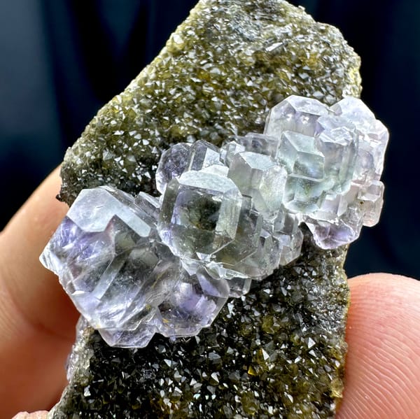 Glassy blue-green stepped fluorite cubes on olive quartz from Fujian, China, close-up of the crystal faces