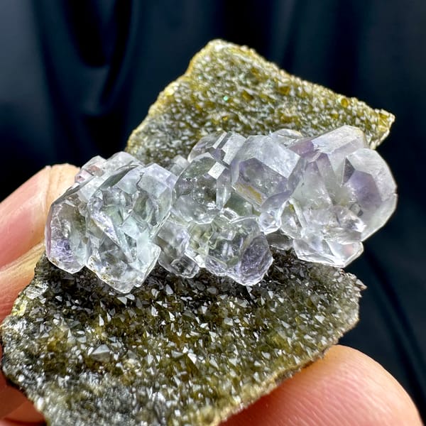 Glassy blue-green stepped fluorite cubes on olive quartz from Fujian, China, top view