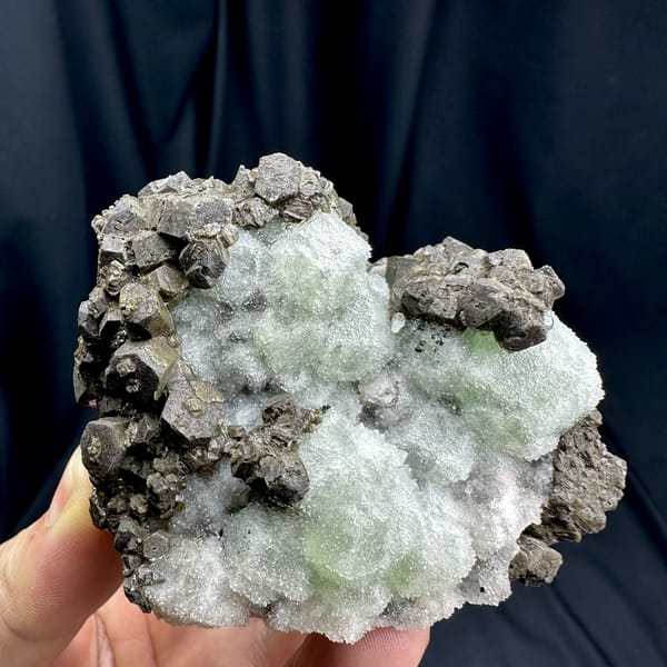 Frosted mint-green fluorite between chocolate-brown calcite from Fujian, China, top view