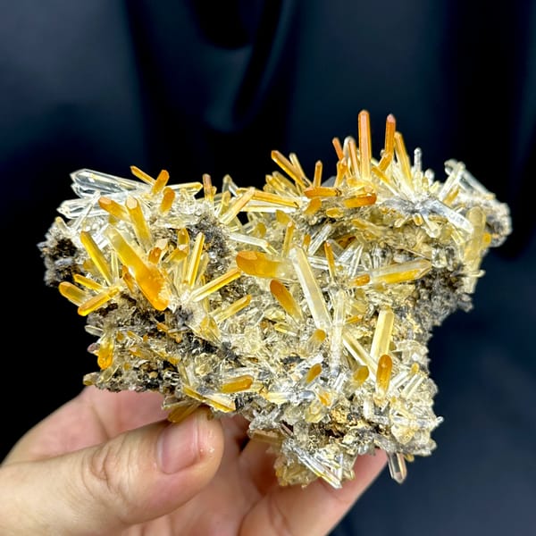 Cluster of clear quartz needles with mango-orange tips from Jinkouhe, Sichuan, China, second angle