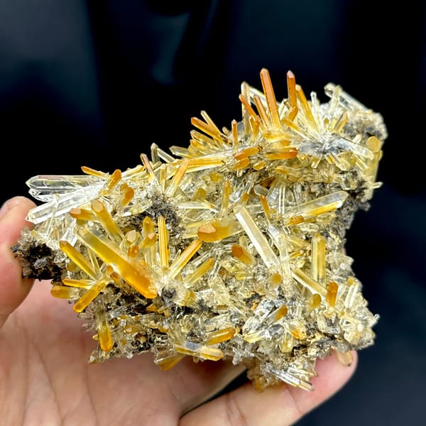 Cluster of clear quartz needles with mango-orange tips from Jinkouhe, Sichuan, China, top view