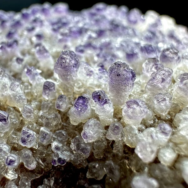 Purple yttrofluorite balls on white gypsum mound from Guizhou, China, second angle