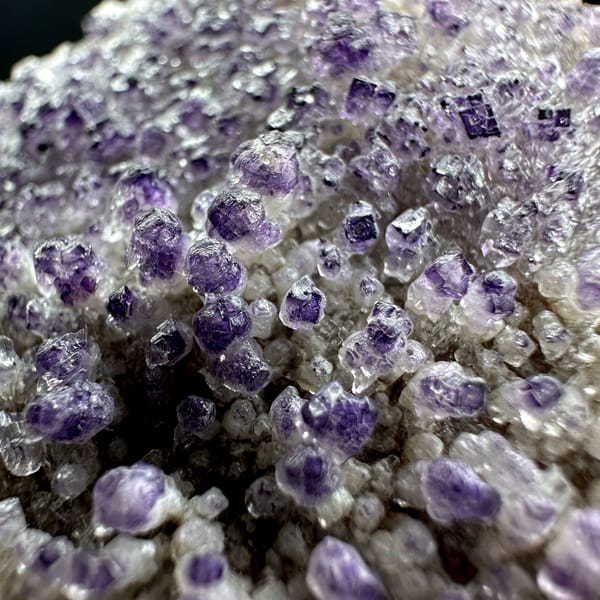 Purple yttrofluorite balls on white gypsum mound from Guizhou, China, reverse side