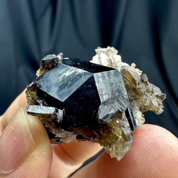 Jet-black tourmaline crystal with smoky quartz and feldspar from Namibia, reverse side