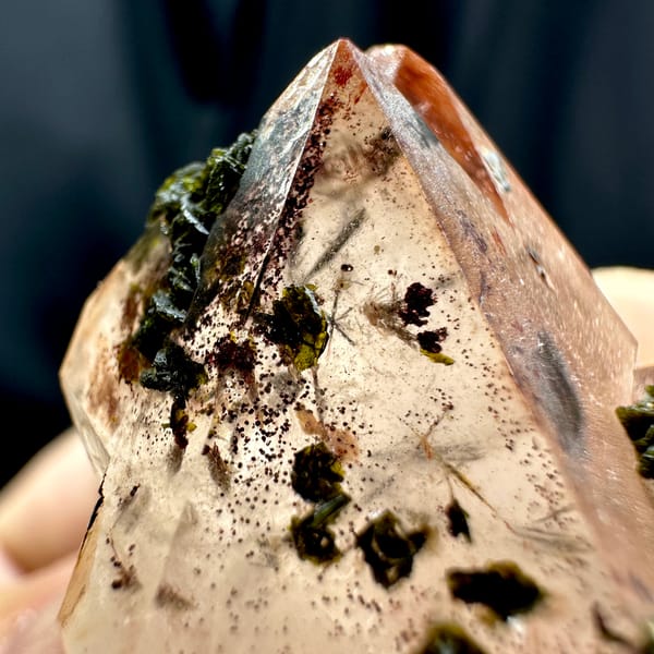 Orange-red garden quartz floater with green epidote from Sichuan, China, close-up of the crystal faces