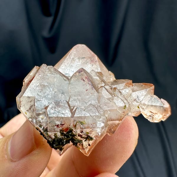 Orange-red garden quartz floater with green epidote from Sichuan, China, top view