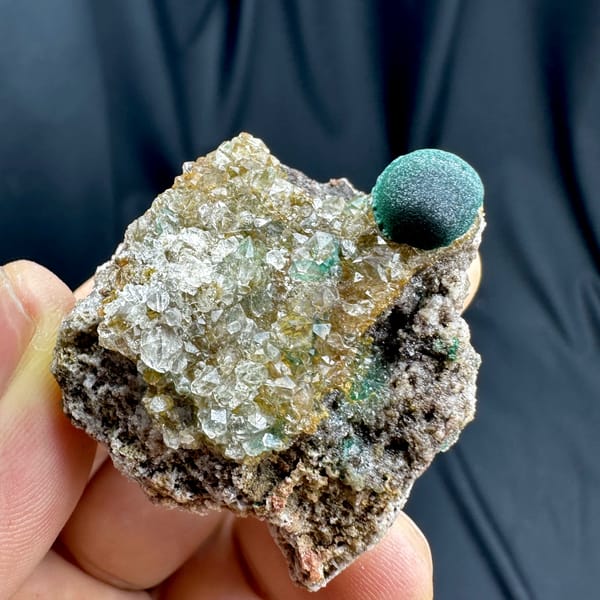 Single velvet-green malachite ball on sugary quartz from DR Congo, close-up of the crystal faces