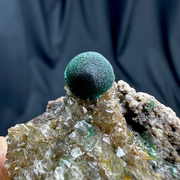 Single velvet-green malachite ball on sugary quartz from DR Congo, top view