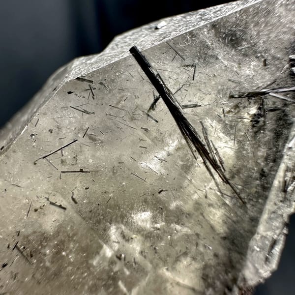 Large smoky quartz crystal with black tourmaline base from Namibia, close-up of the crystal faces