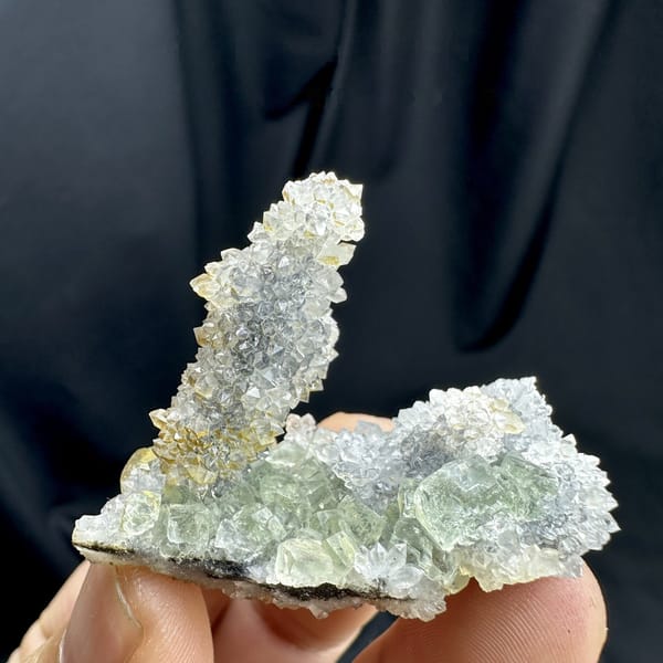 Pale green fluorite plate with quartz-druse stalk from Fujian, China, side view