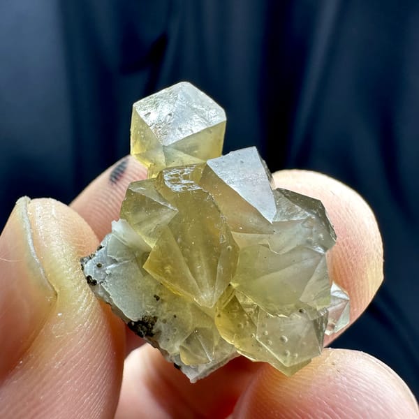 Yellow diamond-shaped quartz crystals with goethite from Inner Mongolia, China, close-up of the crystal faces
