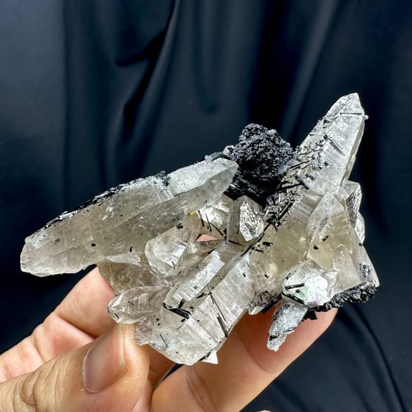 Clear smoky quartz prisms with black tourmaline cluster from Namibia, close-up of the crystal faces