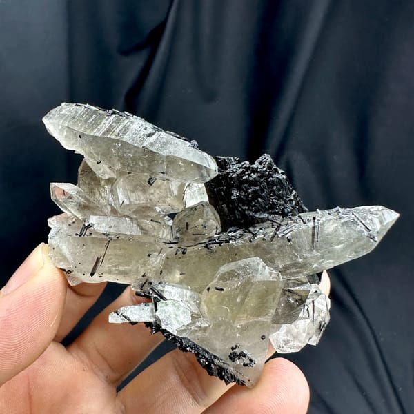 Clear smoky quartz prisms with black tourmaline cluster from Namibia, reverse side