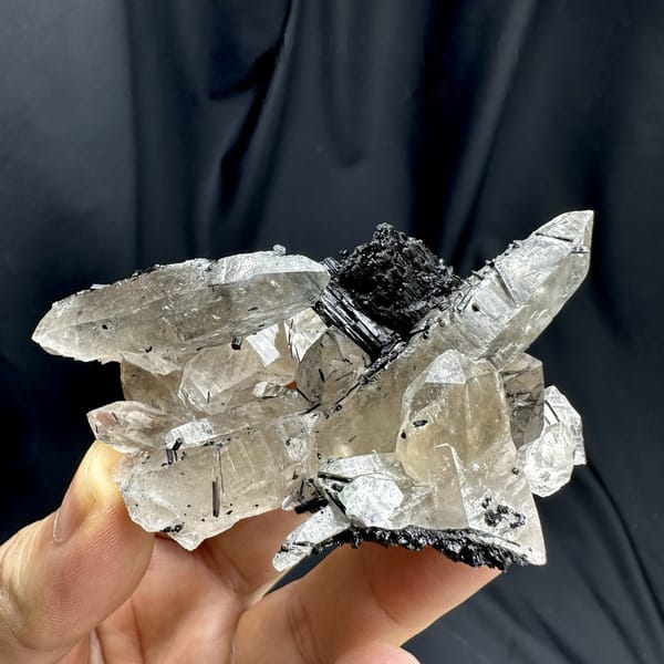 Clear smoky quartz prisms with black tourmaline cluster from Namibia, detail of the matrix contact