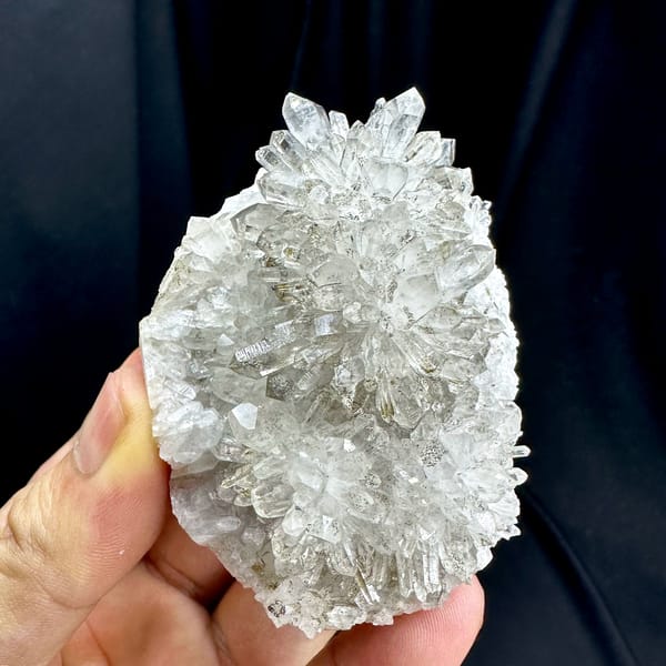Chrysanthemum-quartz cluster of radiating clear needles from Fujian, China, close-up of the crystal faces