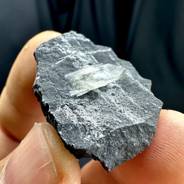 Sword-tip transparent baryte blade on dark grey rock from Guangxi, China, second angle