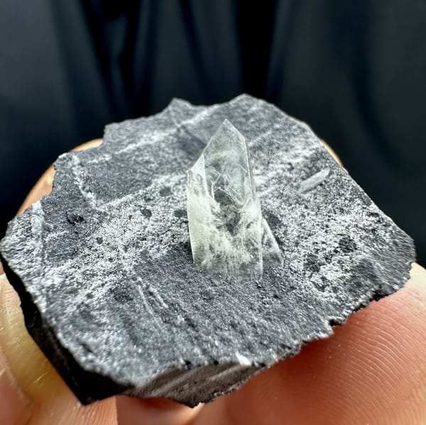 Sword-tip transparent baryte blade on dark grey rock from Guangxi, China, top view