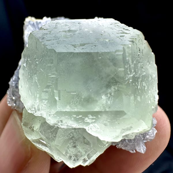 Large glass-clear pale green fluorite cube on lavender druse from Fujian, China, second angle