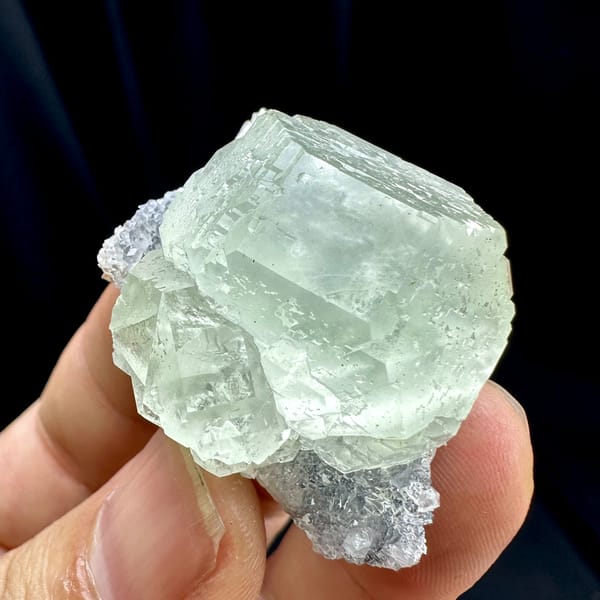 Large glass-clear pale green fluorite cube on lavender druse from Fujian, China, reverse side