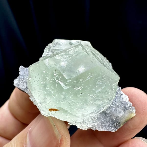 Large glass-clear pale green fluorite cube on lavender druse from Fujian, China, top view