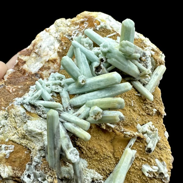 Pale green plumbogummite prisms on ochre matrix from Guangxi, China, close-up of the crystal faces