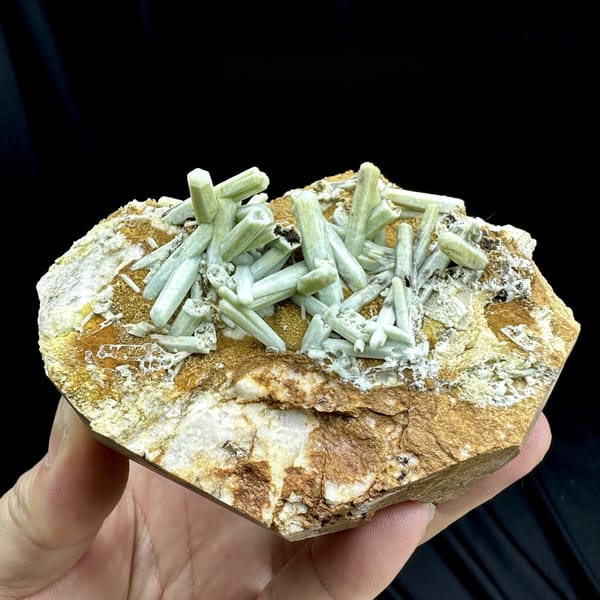 Pale green plumbogummite prisms on ochre matrix from Guangxi, China, detail of the matrix contact