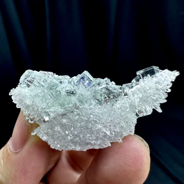 Glass-clear fluorite cubes with faint blue tint on quartz from Zhejiang, China, close-up of the crystal faces