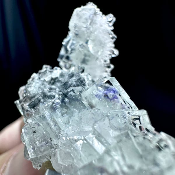 Glass-clear fluorite cubes with faint blue tint on quartz from Zhejiang, China, reverse side