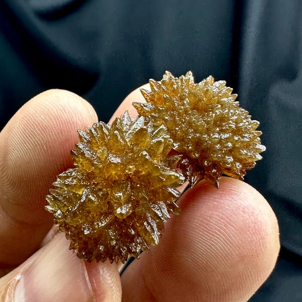 Amber calcite balls of radiating crystals from Guizhou, China, reverse side