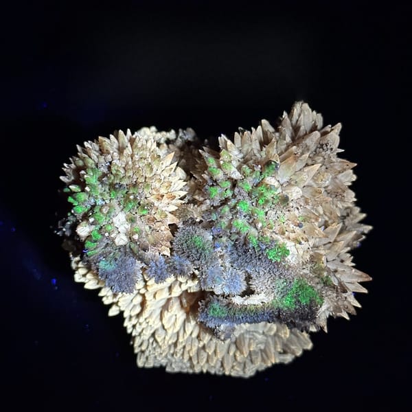 Amber calcite spires with hyalite opal from Guizhou, China, detail of the matrix contact