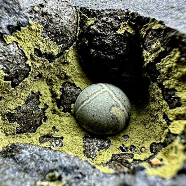 Matcha-green calcite ball inside yellow-lined rock pocket from Fujian, China, second angle