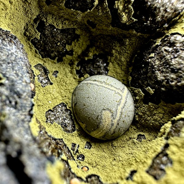 Matcha-green calcite ball inside yellow-lined rock pocket from Fujian, China, reverse side