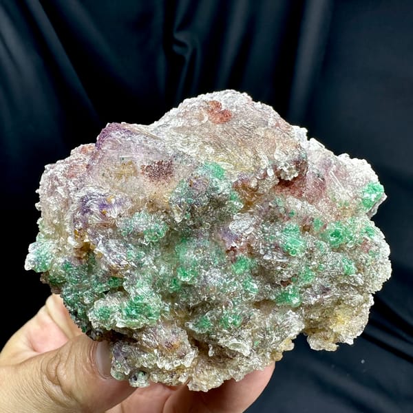 Green malachite over purple-edged fluorite in gypsum from Guizhou, China, close-up of the crystal faces