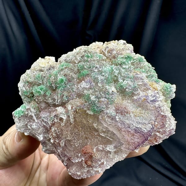 Green malachite over purple-edged fluorite in gypsum from Guizhou, China, detail of the matrix contact