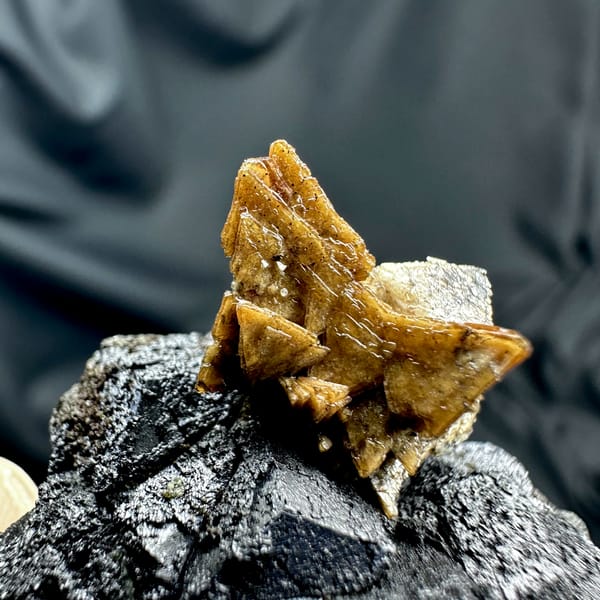 Black magnetite crystals with golden helvine tuft from Inner Mongolia, China, close-up of the crystal faces