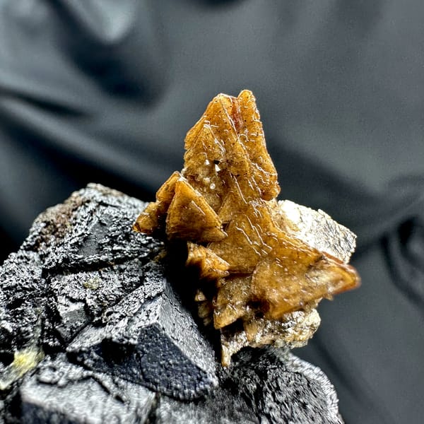 Black magnetite crystals with golden helvine tuft from Inner Mongolia, China, top view