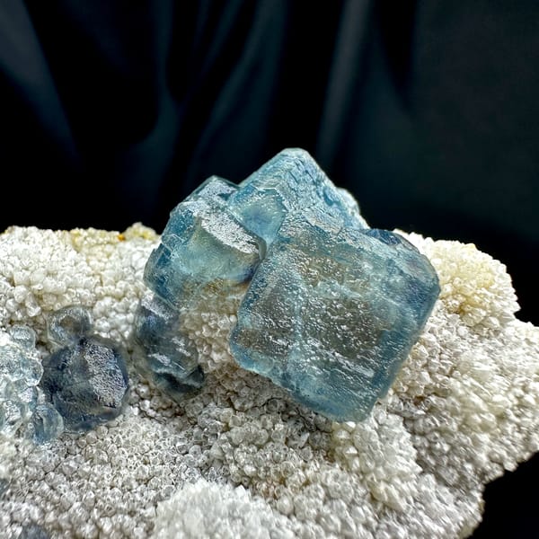 Muted teal-blue fluorite cubes on white sugar-quartz from Fujian, China, second angle