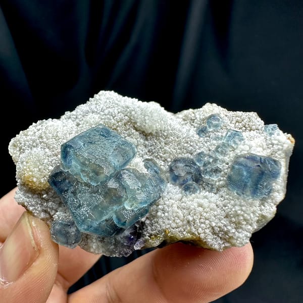 Muted teal-blue fluorite cubes on white sugar-quartz from Fujian, China, reverse side