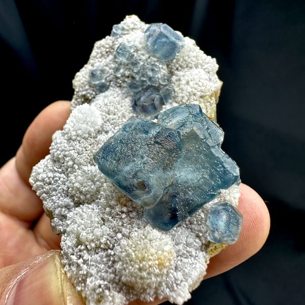 Muted teal-blue fluorite cubes on white sugar-quartz from Fujian, China, top view