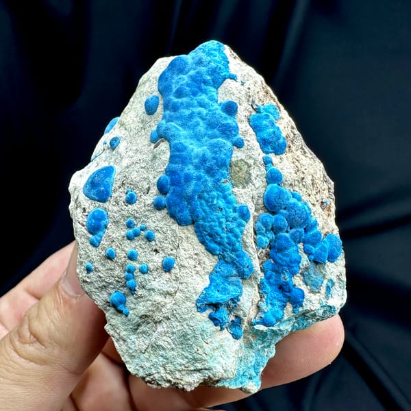 Bright blue chrysocolla balls on grey rock from DR Congo, second angle