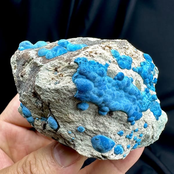 Bright blue chrysocolla balls on grey rock from DR Congo, top view