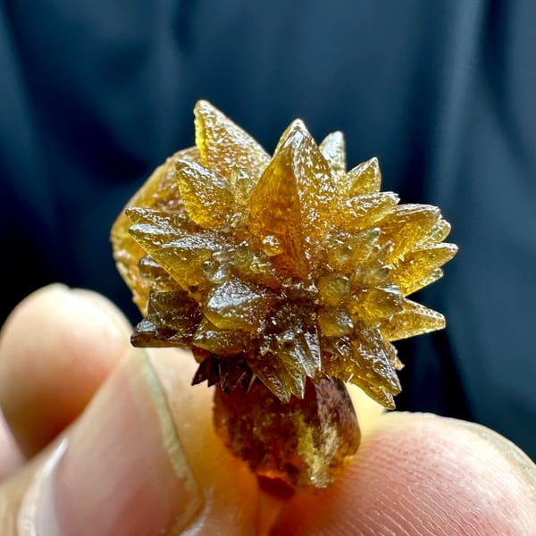 Single amber calcite flower of radiating crystals from Guizhou, China, reverse side