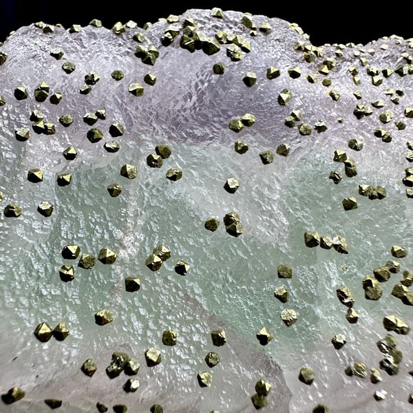 Large lavender-green fluorite floater dusted with pyrite from Jiangxi, China, second angle