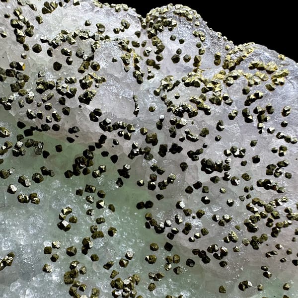 Large lavender-green fluorite floater dusted with pyrite from Jiangxi, China, top view