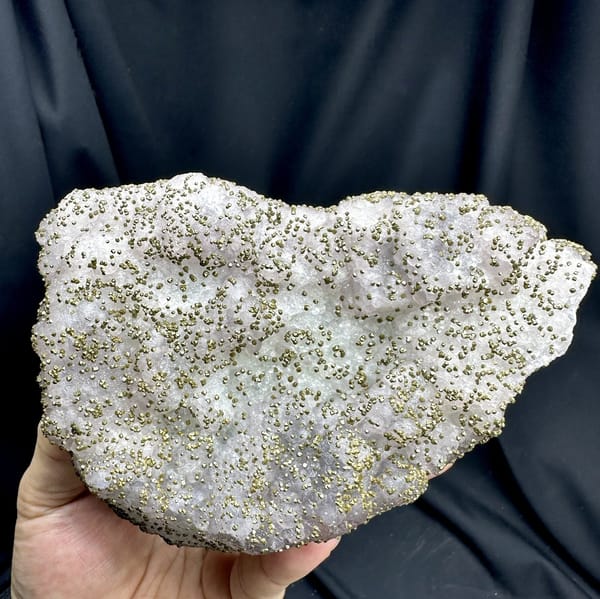 Large lavender-green fluorite floater dusted with pyrite from Jiangxi, China, detail of the matrix contact