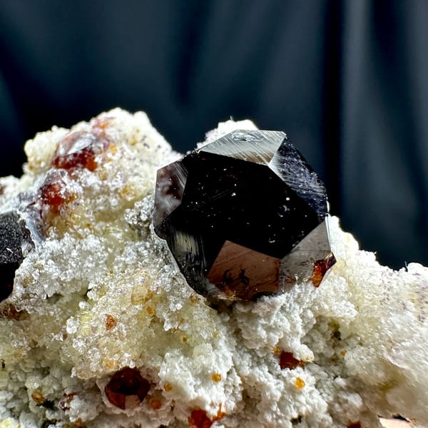 Large wine-red garnets with hyalite opal on white feldspar from Yunxiao, Fujian, China, reverse side