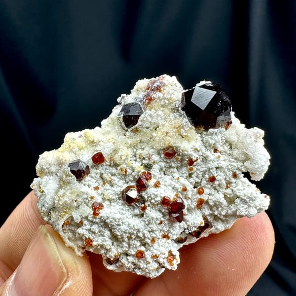 Large wine-red garnets with hyalite opal on white feldspar from Yunxiao, Fujian, China, top view