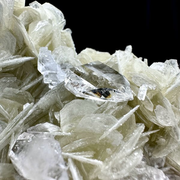 Ultra-clear quartz points among pearly muscovite from Xuebaoding, Sichuan, China, top view